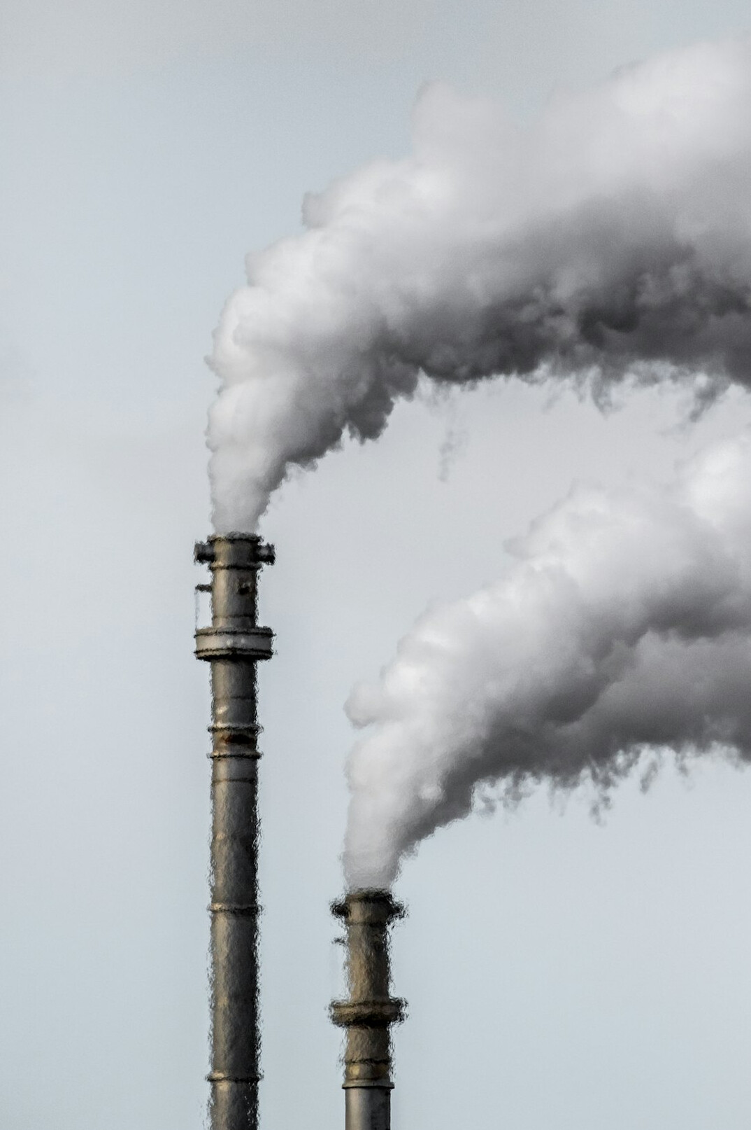 Industrial smokestacks emitting dark smoke