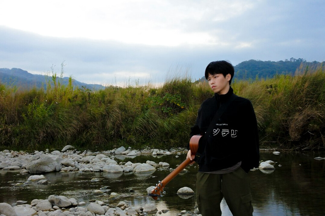 Journalist collecting a water sample at a riverbank